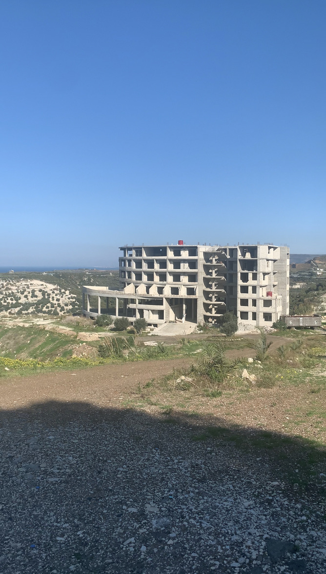 Coastal building under construction with the sea in the background